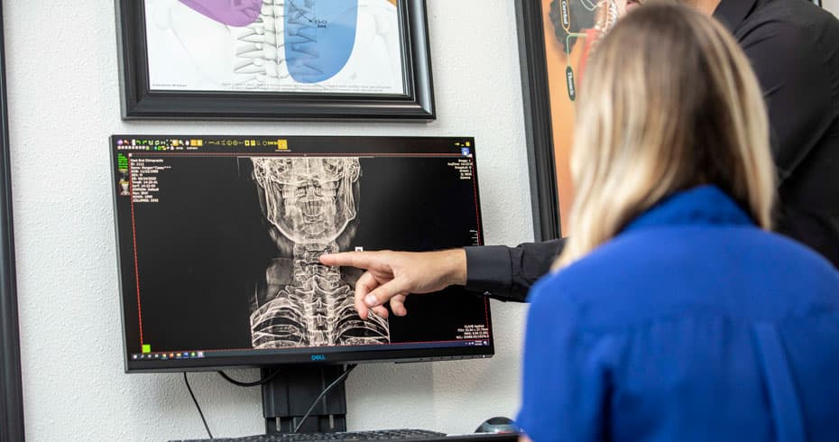 Photo: Austin chiropractor pointing out what is causing this client neck pain.